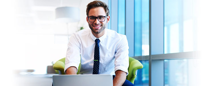 handsome man smiling at you in work enviroment